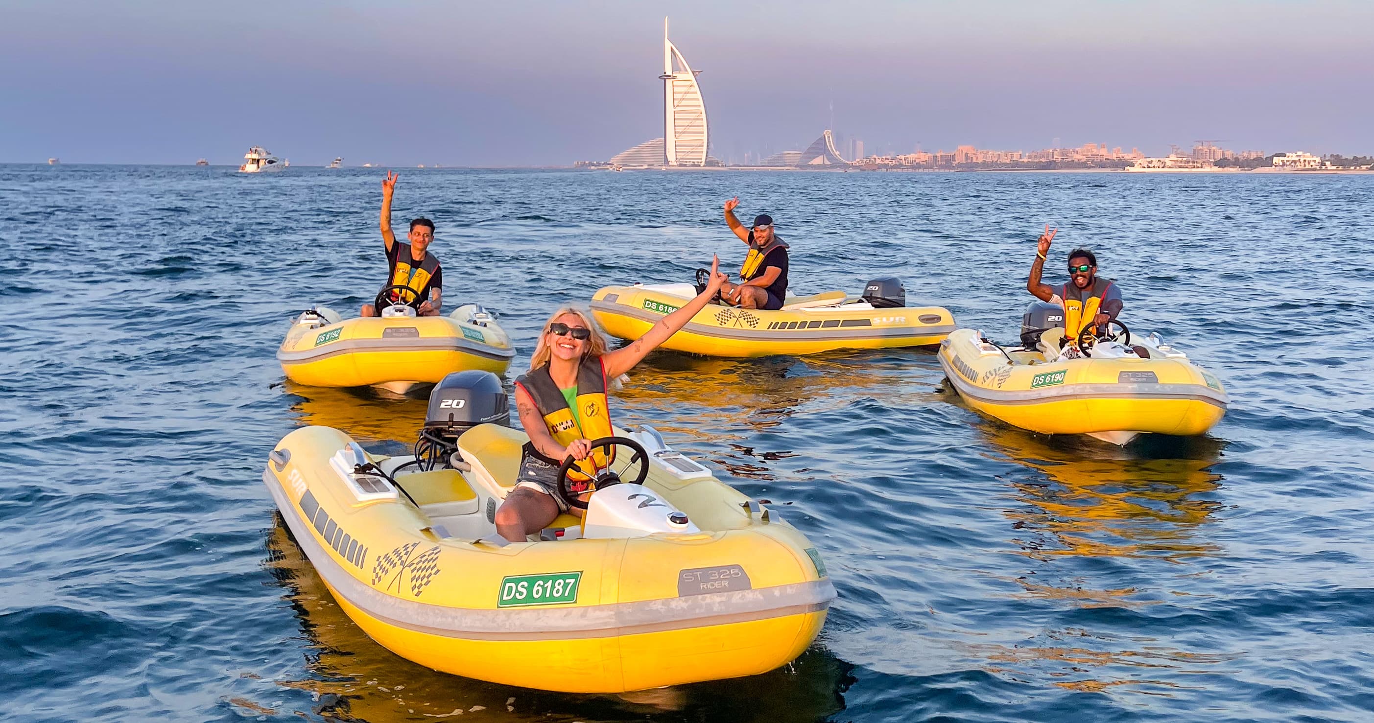 Self-drive speedboat in front of the Burj Al Arab at golden hour